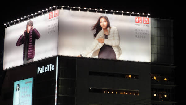 large billboards for uniqlo clothing items on topof a building